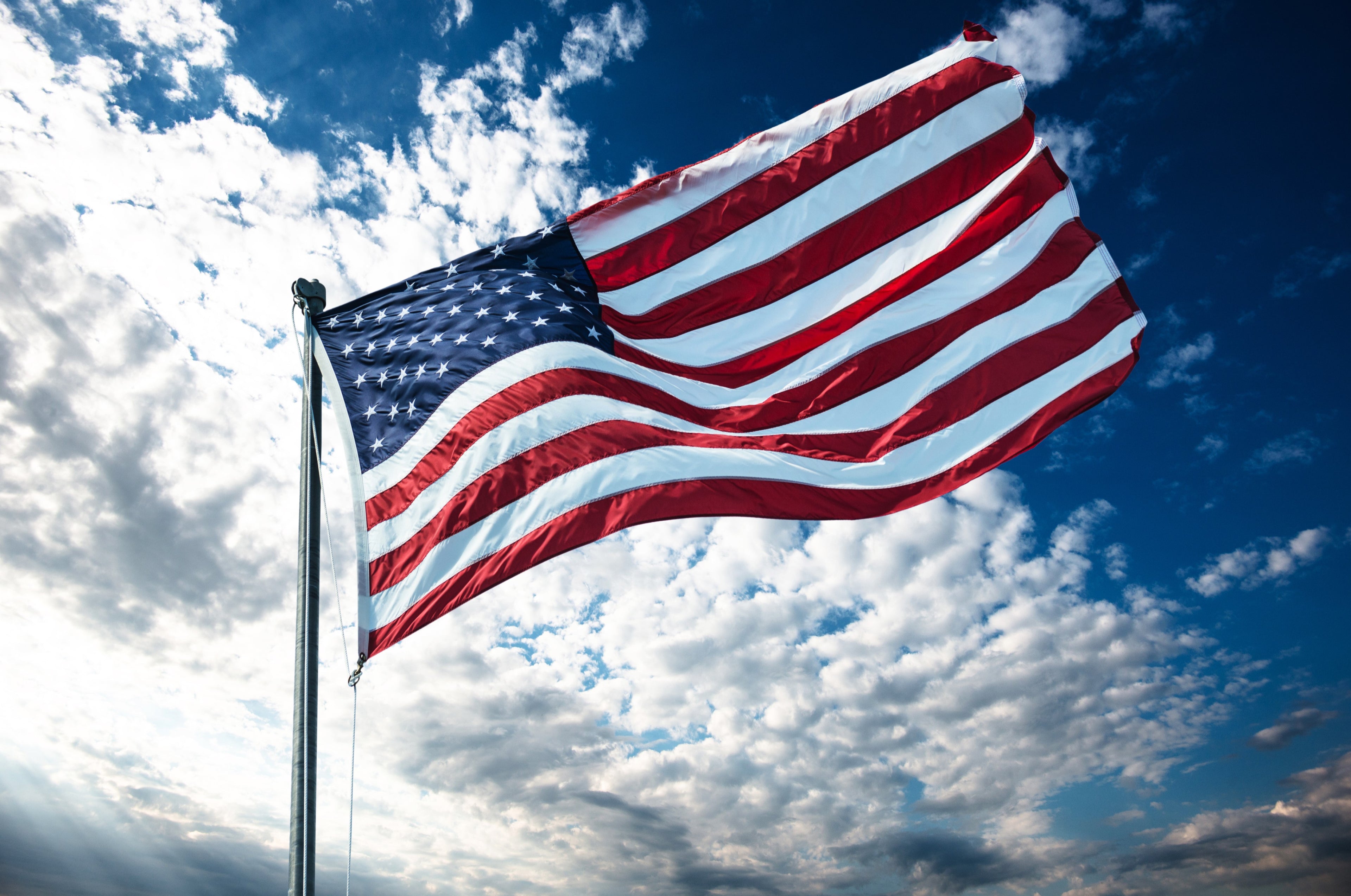 American flag waving proudly, symbolizing support for military and law enforcement through Victory VCI’s VIP discount program.